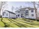 Charming white brick home with dark trim and a lush green lawn at 1355 Forest Hills Dr, Westfield, IN 46074