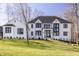 Stunning white brick home with black trim and a well-manicured lawn at 1355 Forest Hills Dr, Westfield, IN 46074