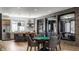 Open concept game room features a poker table, kitchen with an island, and brick walls at 1355 Forest Hills Dr, Westfield, IN 46074