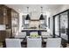 A modern kitchen features custom cabinetry, a central island, stainless steel appliances, and a bright, open dining area at 1355 Forest Hills Dr, Westfield, IN 46074