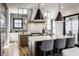 A kitchen with white countertops, gray cabinets, stainless steel appliances, and modern pendant lighting above a spacious island at 1355 Forest Hills Dr, Westfield, IN 46074
