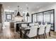 A gourmet kitchen featuring stone countertops, a large island, stainless steel appliances, and a spacious dining area at 1355 Forest Hills Dr, Westfield, IN 46074