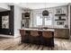 Modern kitchen featuring barstool seating at the island, stainless appliances, and stylish lighting at 1355 Forest Hills Dr, Westfield, IN 46074