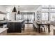 Open kitchen and dining area with a view to the outside, with large windows and modern lighting at 1355 Forest Hills Dr, Westfield, IN 46074