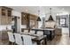 An open-concept kitchen and dining area features custom wood cabinets, a central island, and modern appliances at 1355 Forest Hills Dr, Westfield, IN 46074