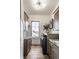 Bright laundry room with modern washer and dryer, storage cabinets, and a window at 1355 Forest Hills Dr, Westfield, IN 46074