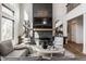 A modern living room with large windows, a fireplace, stylish decor, and plenty of seating at 1355 Forest Hills Dr, Westfield, IN 46074