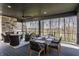 Covered patio features an outdoor fireplace, dining area, and serene views of the yard at 1355 Forest Hills Dr, Westfield, IN 46074