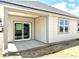Covered patio space featuring a sliding glass door and bright windows, perfect for outdoor living and entertainment at 1419 School Bell Dr, Greenwood, IN 46143