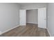 Neutral-toned bedroom with wood floors featuring a large doorway to another room, providing a calming and spacious retreat at 14859 Amber Light Dr, Westfield, IN 46074
