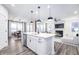 Spacious open-concept kitchen and living room with stainless steel appliances and a large kitchen island at 14859 Amber Light Dr, Westfield, IN 46074