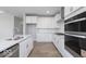 Close up of kitchen with island sink, stainless appliances, and white cabinets at 14859 Amber Light Dr, Westfield, IN 46074