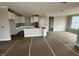 Bright, unfinished kitchen with white cabinets, a kitchen island, and new appliances at 14859 Amber Light Dr, Westfield, IN 46074