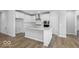 Bright, open kitchen with island, hardwood floors and stainless appliances at 14859 Amber Light Dr, Westfield, IN 46074