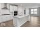 Modern kitchen featuring white cabinets, stainless steel appliances, and a large center island at 14859 Amber Light Dr, Westfield, IN 46074