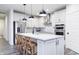 Bright kitchen with a large island, stainless steel appliances, pendant lighting, and white cabinets at 14859 Amber Light Dr, Westfield, IN 46074