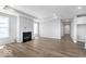Spacious living room with fireplace, hardwood floors, large windows, and tray ceiling, offering a bright and inviting atmosphere at 14859 Amber Light Dr, Westfield, IN 46074