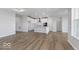 Bright and airy living room showcases an open floor plan with hardwood flooring and a modern kitchen with white cabinets at 14859 Amber Light Dr, Westfield, IN 46074