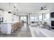 Open concept living room flows into the kitchen with bar seating and stainless steel appliances at 14859 Amber Light Dr, Westfield, IN 46074
