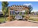 Charming backyard with a wooden pergola swing, landscaped patio, and privacy fencing at 15773 Eastpark Dr, Noblesville, IN 46060
