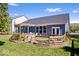 Spacious backyard with a wooden deck, pergola swing, manicured lawn, and privacy fence at 15773 Eastpark Dr, Noblesville, IN 46060