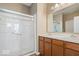 Well-lit bathroom with a double vanity, framed mirror and a walk-in shower at 15773 Eastpark Dr, Noblesville, IN 46060