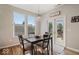 Bright dining area with natural light, a modern table, and access to outdoor space at 15773 Eastpark Dr, Noblesville, IN 46060