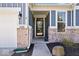 Inviting front entrance with brick accents, a charming storm door, and decorative landscaping at 15773 Eastpark Dr, Noblesville, IN 46060