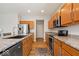 Modern kitchen featuring stainless steel appliances, granite countertops, and wood cabinets at 15773 Eastpark Dr, Noblesville, IN 46060