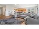 Spacious open-concept living room with an oversized gray sectional couch, flowing into the kitchen at 15773 Eastpark Dr, Noblesville, IN 46060