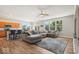 Open-concept living room with hardwood floors, lots of natural light, and a large gray sectional couch at 15773 Eastpark Dr, Noblesville, IN 46060