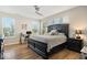 Tranquil main bedroom with large windows, ceiling fan, and hardwood floors at 15773 Eastpark Dr, Noblesville, IN 46060