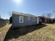 Blue home exterior with views of the backyard lawn at 1618 W 17Th St, Anderson, IN 46016