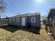 Exterior back of home with blue siding and a grassy lawn at 1618 W 17Th St, Anderson, IN 46016