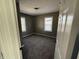 Cozy bedroom featuring neutral walls, plush carpeting, and natural light through windows at 1618 W 17Th St, Anderson, IN 46016