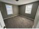 This bedroom features neutral walls, carpet, and two windows for natural light at 1618 W 17Th St, Anderson, IN 46016