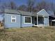 Light blue exterior with updated windows and well-maintained landscaping at 1618 W 17Th St, Anderson, IN 46016