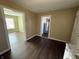 View of the hallway and a glimpse into other rooms with hardwood flooring at 1618 W 17Th St, Anderson, IN 46016