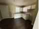 Functional kitchen featuring white cabinetry, laminate countertops, and newer flooring at 1618 W 17Th St, Anderson, IN 46016