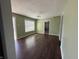Spacious living room featuring hardwood floors, fresh paint, and ample natural light at 1618 W 17Th St, Anderson, IN 46016