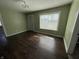 A spacious living room with hardwood flooring and a large window at 1618 W 17Th St, Anderson, IN 46016