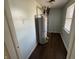 A utility room features the water heater and wood look flooring at 1618 W 17Th St, Anderson, IN 46016