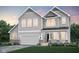 Beautiful two-story home featuring gray siding, a two-car garage, and manicured landscaping at 16467 Alps Rd, Noblesville, IN 46060