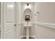 Stylish powder room with pedestal sink, oval mirror, and elegant light fixture at 16544 Gaither Ct, Westfield, IN 46074