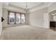 Expansive bedroom features plush carpeting, a tray ceiling, and a decorative chandelier at 16544 Gaither Ct, Westfield, IN 46074