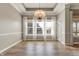 Bright dining room with large windows, elegant chandelier, and neutral wall color at 16544 Gaither Ct, Westfield, IN 46074