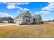 Attractive house featuring a three-car garage, stone details, and a spacious lawn at 16544 Gaither Ct, Westfield, IN 46074