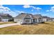Charming home with a three-car garage and stone accents surrounded by a well-manicured lawn at 16544 Gaither Ct, Westfield, IN 46074