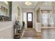 Elegant entrance features hardwood floors, decor table, and a charming front door at 16544 Gaither Ct, Westfield, IN 46074