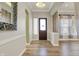Inviting foyer with hardwood floors, elegant mirror, and stylish front door at 16544 Gaither Ct, Westfield, IN 46074